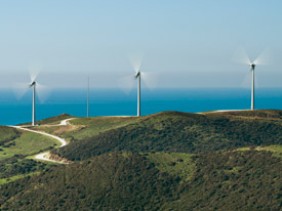 3 éoliennes avec la mer au fond