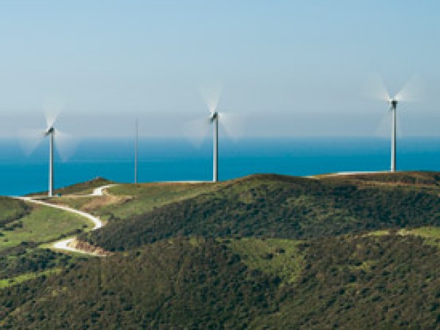 3 éoliennes avec la mer au fond